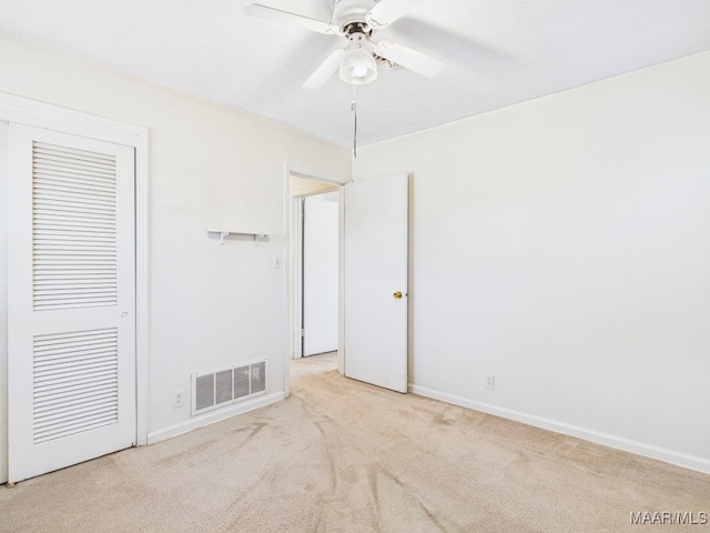 unfurnished bedroom with visible vents, baseboards, a ceiling fan, a closet, and carpet