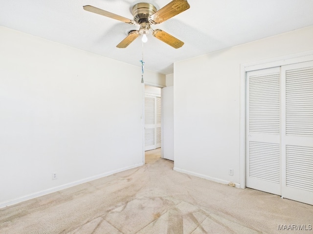 unfurnished bedroom featuring a ceiling fan, carpet, baseboards, and a closet