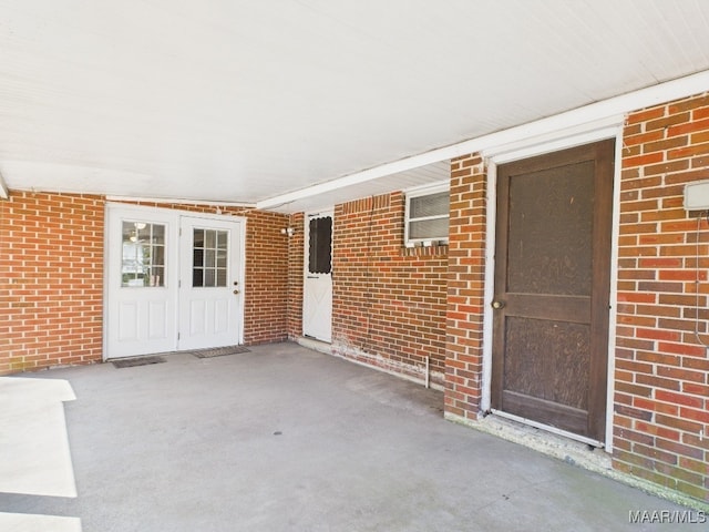 entrance to property featuring brick siding