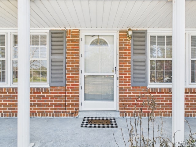 entrance to property with brick siding