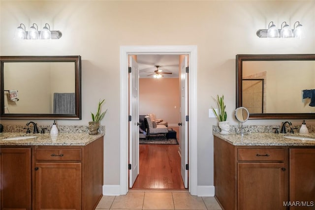 bathroom with two vanities, a sink, ensuite bathroom, and tile patterned floors