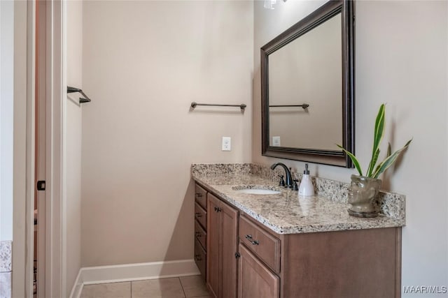 bathroom with tile patterned flooring, vanity, and baseboards