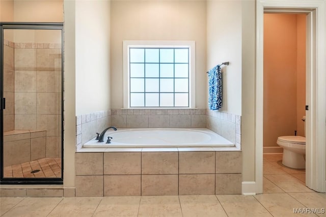 bathroom with toilet, tile patterned flooring, a bath, and a shower stall