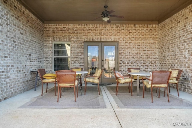 view of patio / terrace featuring outdoor dining space, french doors, and ceiling fan