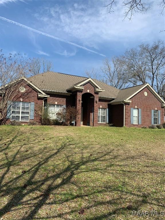 single story home with brick siding and a front yard