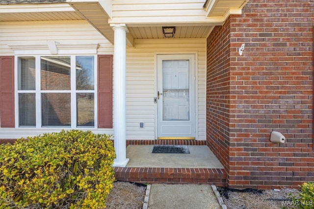 property entrance with brick siding