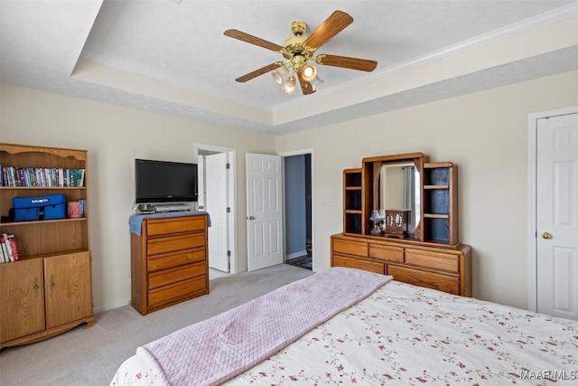 bedroom featuring carpet floors, a raised ceiling, ceiling fan, and a textured ceiling