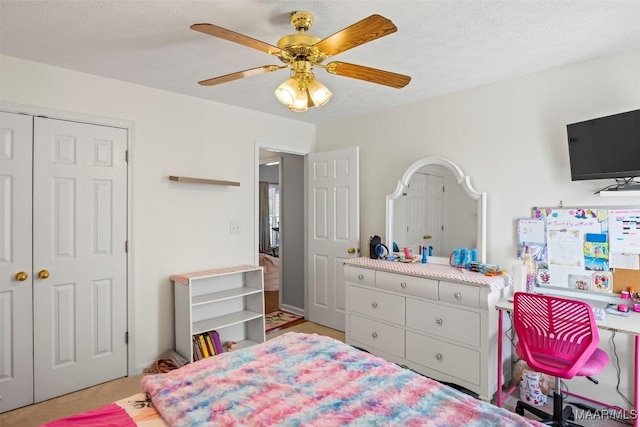 bedroom featuring a textured ceiling, a closet, and a ceiling fan