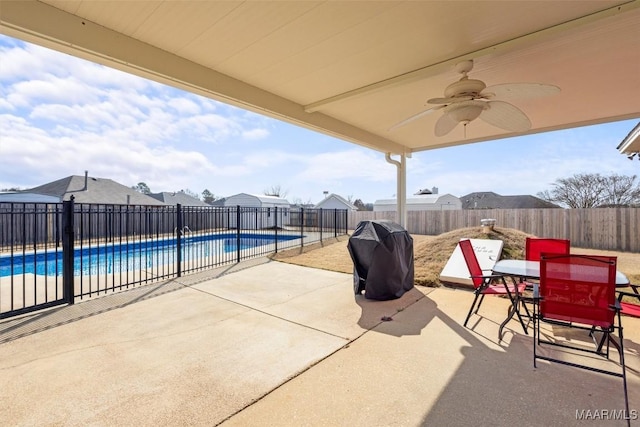 view of patio / terrace featuring ceiling fan, area for grilling, a fenced backyard, and a fenced in pool