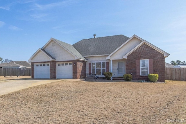 view of front facade with driveway, brick siding, an attached garage, and fence