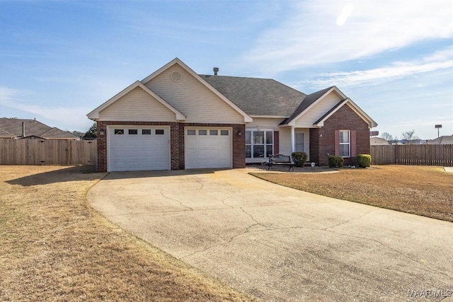 view of front of house with an attached garage, fence, concrete driveway, and brick siding