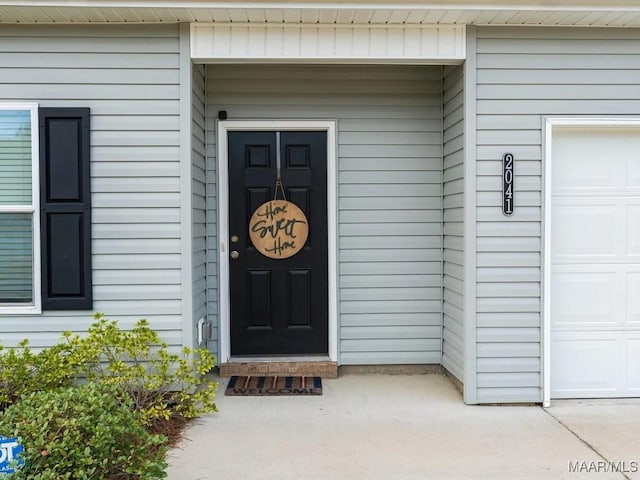 doorway to property with an attached garage