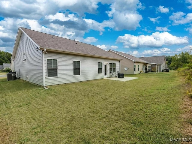 back of property with a shingled roof, central AC unit, a lawn, and a patio