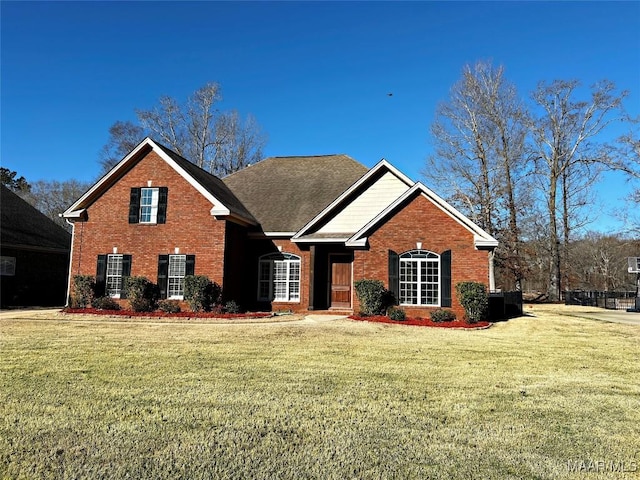 view of front of property with a front yard and brick siding