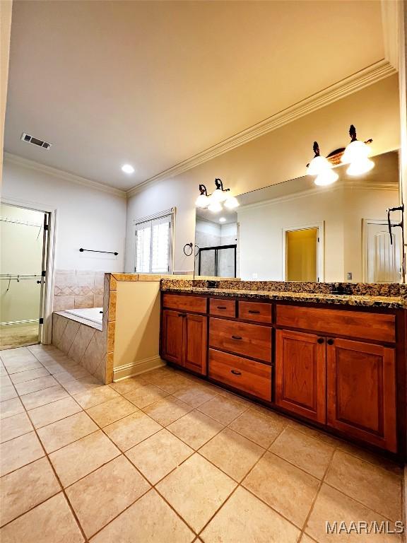 full bathroom featuring a bath, vanity, visible vents, and tile patterned floors