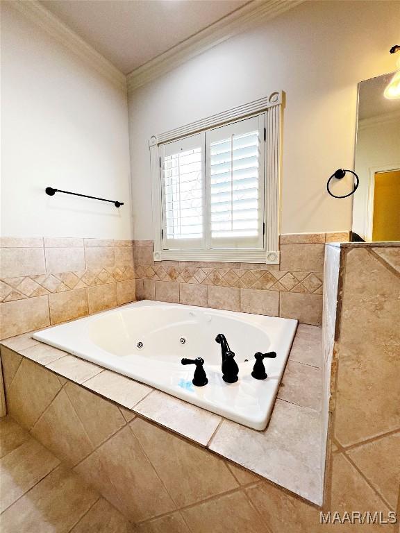 bathroom featuring crown molding, a tub with jets, and tile patterned floors