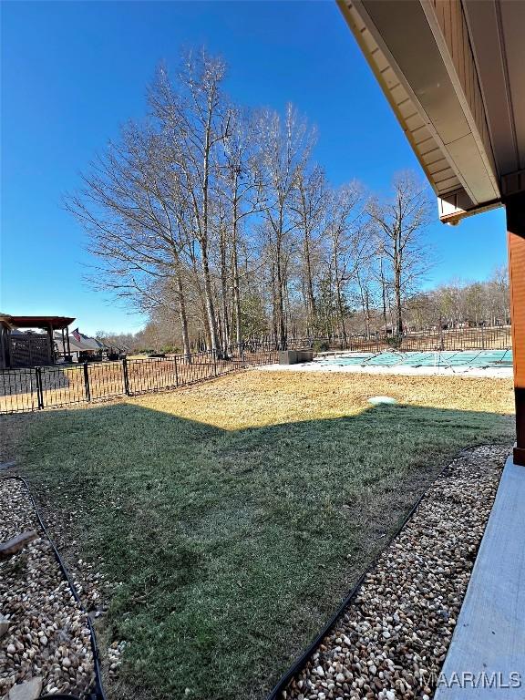 view of yard with fence and a fenced in pool