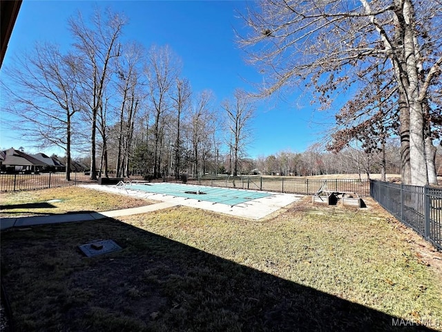 view of swimming pool with a patio, fence, a fenced in pool, and a yard