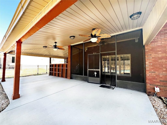 view of patio with a sunroom, ceiling fan, a gate, and fence