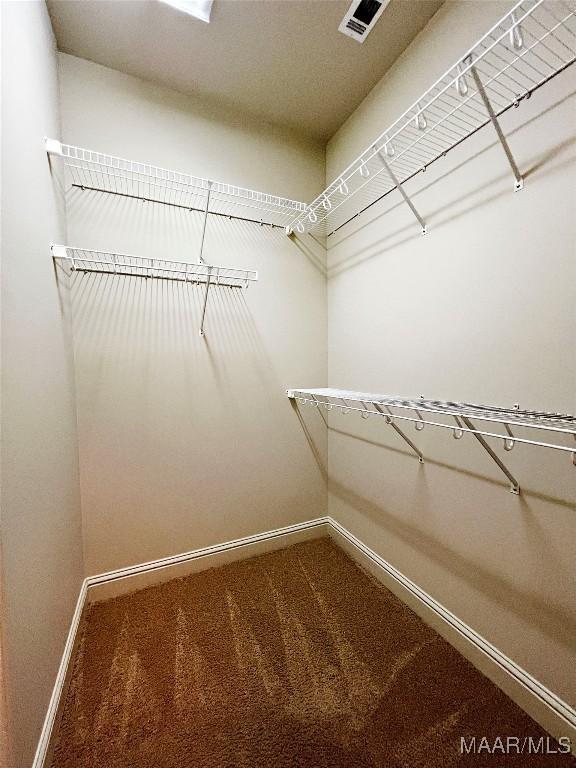 walk in closet with carpet floors and visible vents