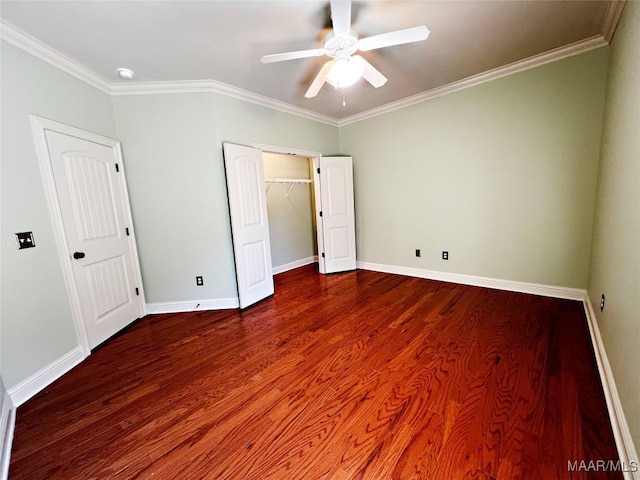 unfurnished bedroom featuring a ceiling fan, crown molding, baseboards, and wood finished floors