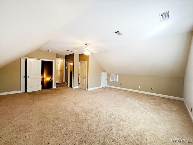 bonus room featuring visible vents, vaulted ceiling, and baseboards