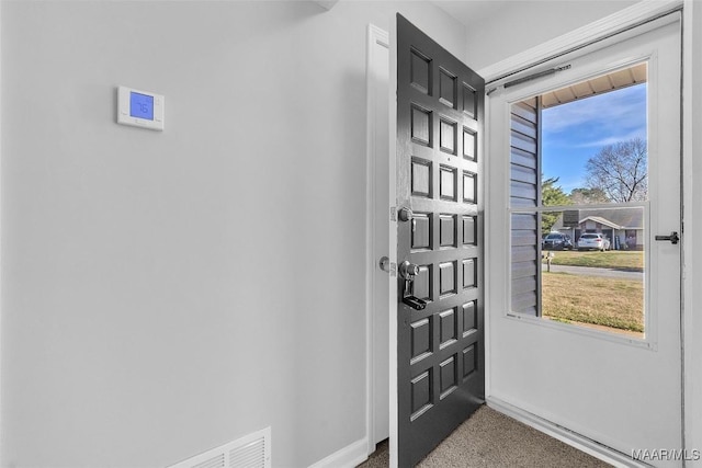 carpeted entryway with baseboards