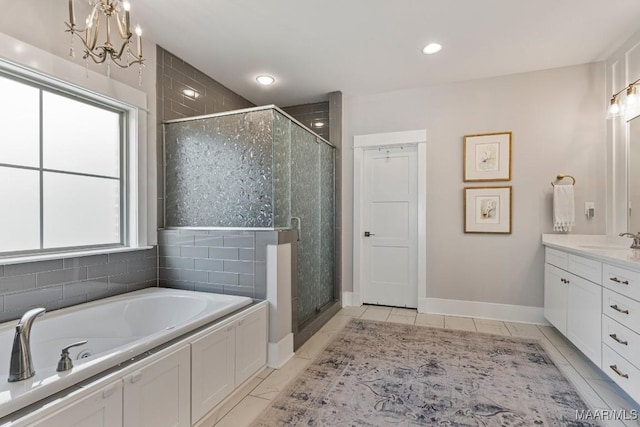 full bathroom with baseboards, a garden tub, a shower stall, and vanity