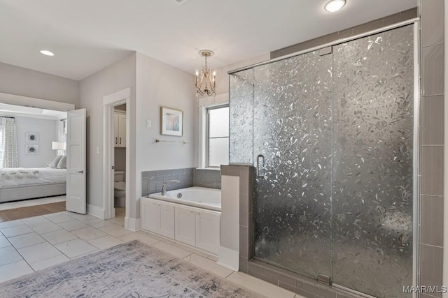 full bath featuring a notable chandelier, toilet, ensuite bathroom, a shower stall, and a bath