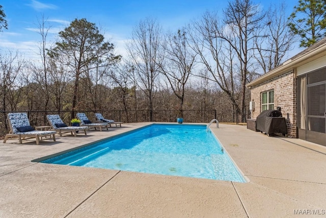 view of pool featuring area for grilling, a patio area, fence, and a fenced in pool