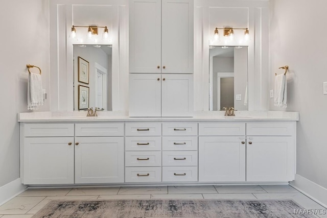 bathroom featuring marble finish floor, baseboards, and vanity