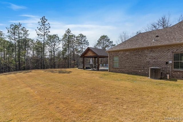 view of yard featuring a gazebo and central AC unit