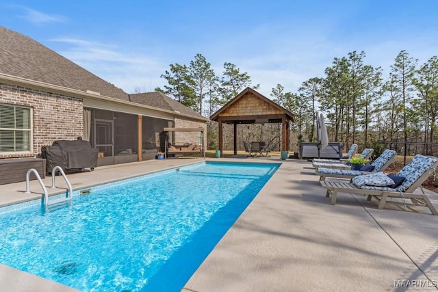 view of pool featuring a fenced in pool, a sunroom, fence, a gazebo, and a patio area