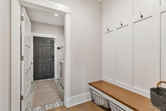 mudroom featuring wood finished floors and baseboards