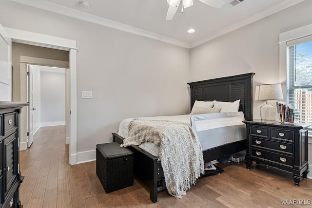 bedroom with recessed lighting, ornamental molding, a ceiling fan, wood finished floors, and baseboards