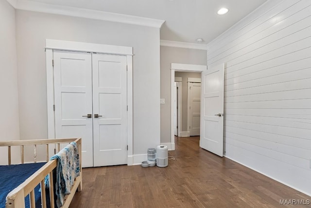 unfurnished bedroom featuring recessed lighting, wood walls, wood finished floors, baseboards, and crown molding