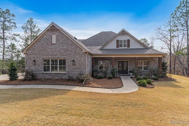 craftsman-style home with roof with shingles, brick siding, and a front lawn