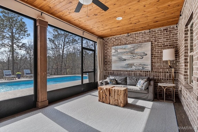 sunroom with wood ceiling and ceiling fan