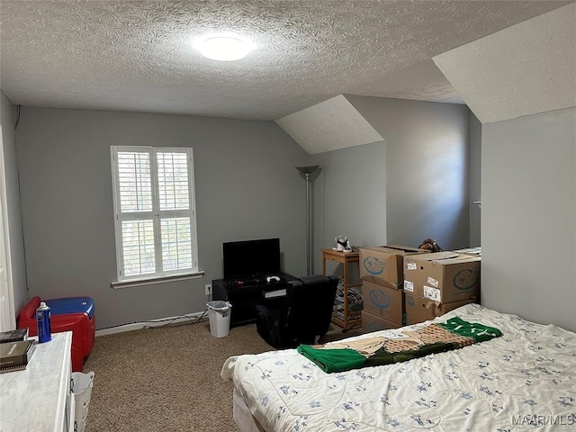 carpeted bedroom with a textured ceiling and lofted ceiling