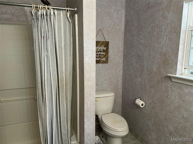 bathroom featuring toilet and shower / tub combo with curtain