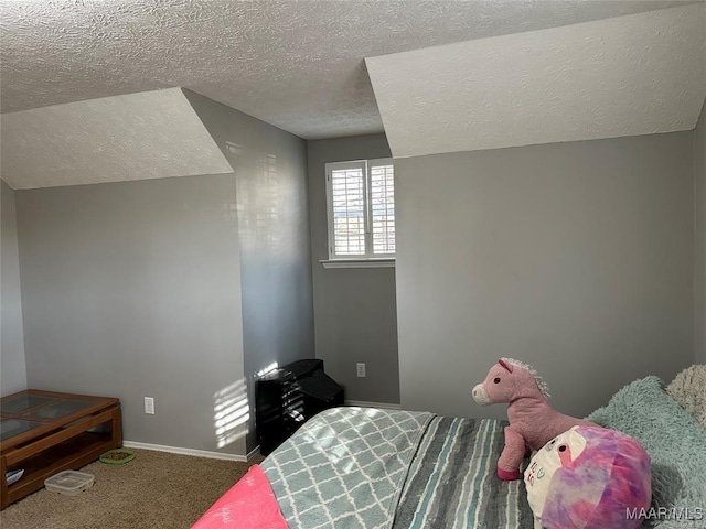 carpeted bedroom featuring baseboards and a textured ceiling