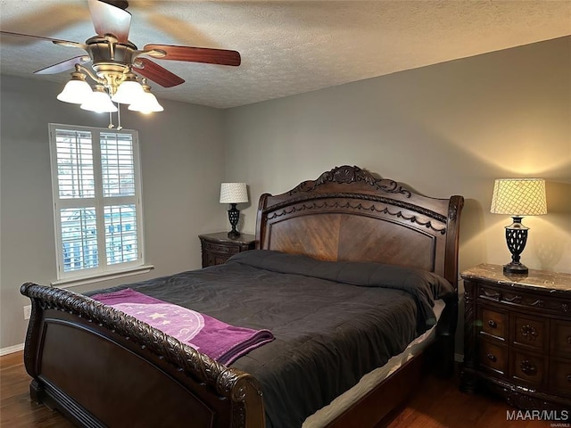bedroom featuring a textured ceiling, ceiling fan, baseboards, and dark wood-style floors