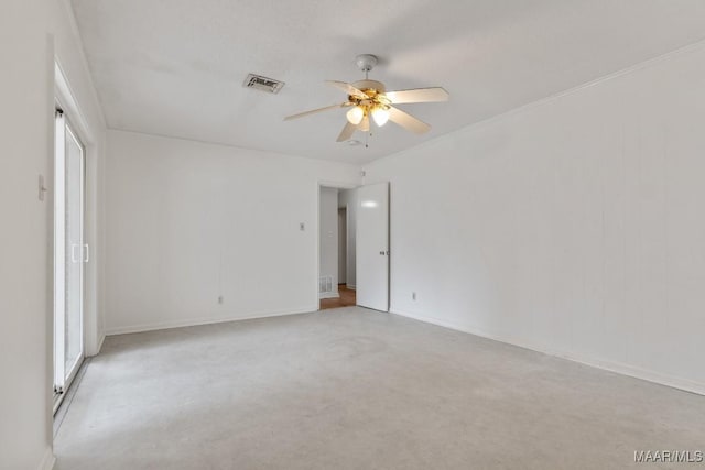 unfurnished room with visible vents and ceiling fan