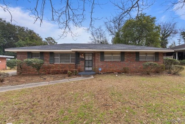 ranch-style house with brick siding and a front yard