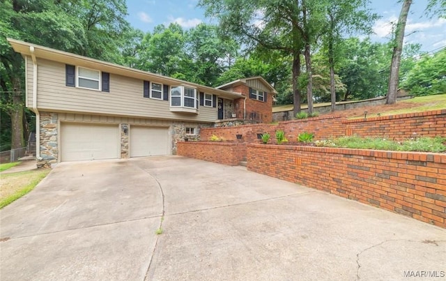 view of front of house featuring a garage, stone siding, and concrete driveway