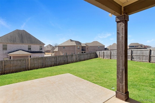 view of yard featuring a residential view, a patio area, and a fenced backyard