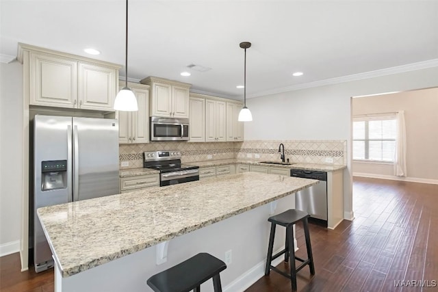 kitchen featuring cream cabinets, tasteful backsplash, stainless steel appliances, and dark wood finished floors