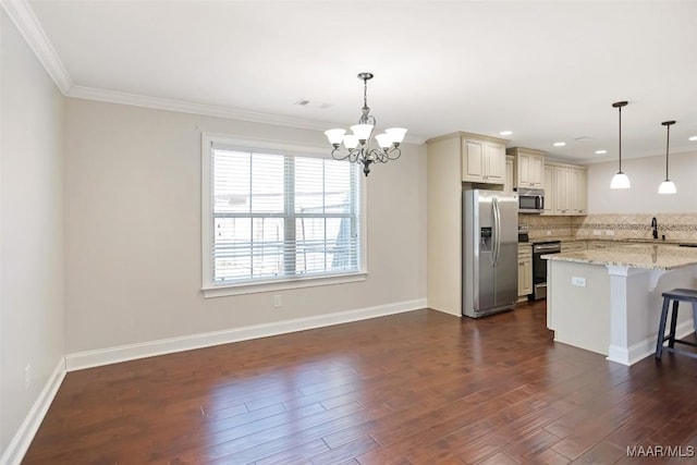 kitchen with decorative backsplash, appliances with stainless steel finishes, a kitchen breakfast bar, dark wood-style flooring, and cream cabinets