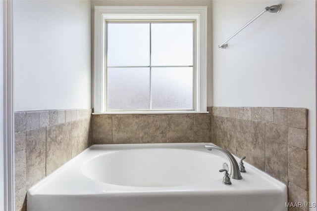 full bathroom with a healthy amount of sunlight and a garden tub