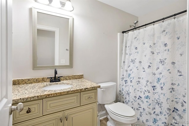 full bath featuring curtained shower, vanity, and toilet